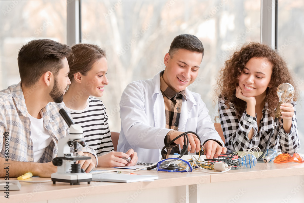 Young people at physics lesson in classroom