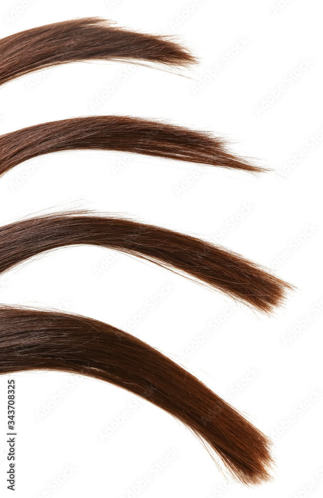 Strands of beautiful straight hair on white background