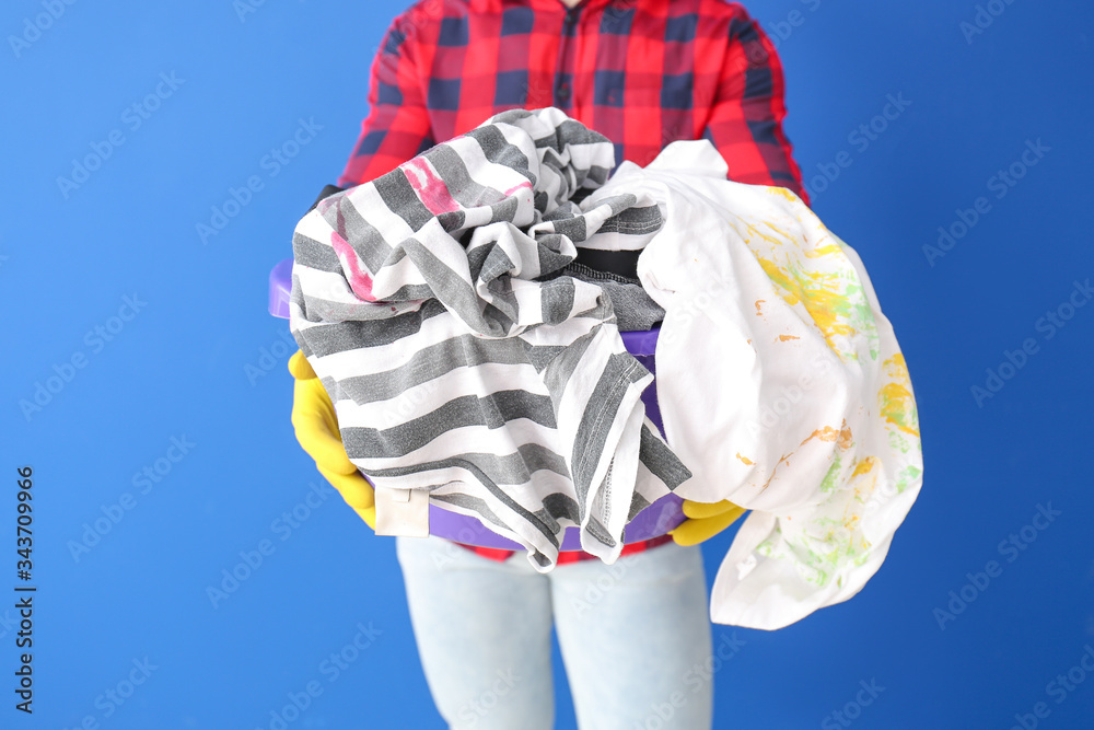 Man with dirty clothes on color background