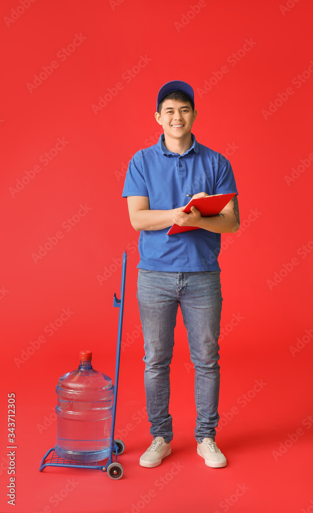 Delivery man with bottle of water on color background