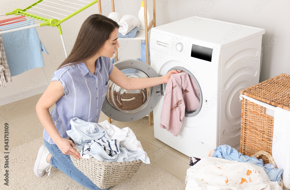 Young woman doing laundry at home