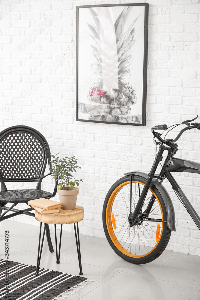 Interior of modern room with chair, table and bicycle