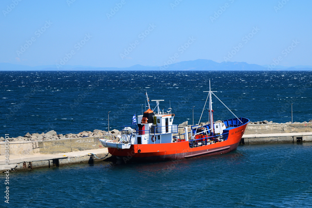 red fishing boat in Kamariotissa harbor (Samothraki) - view taken from ferry