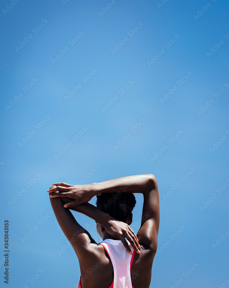 Fitness woman doing warmup exercise outdoors