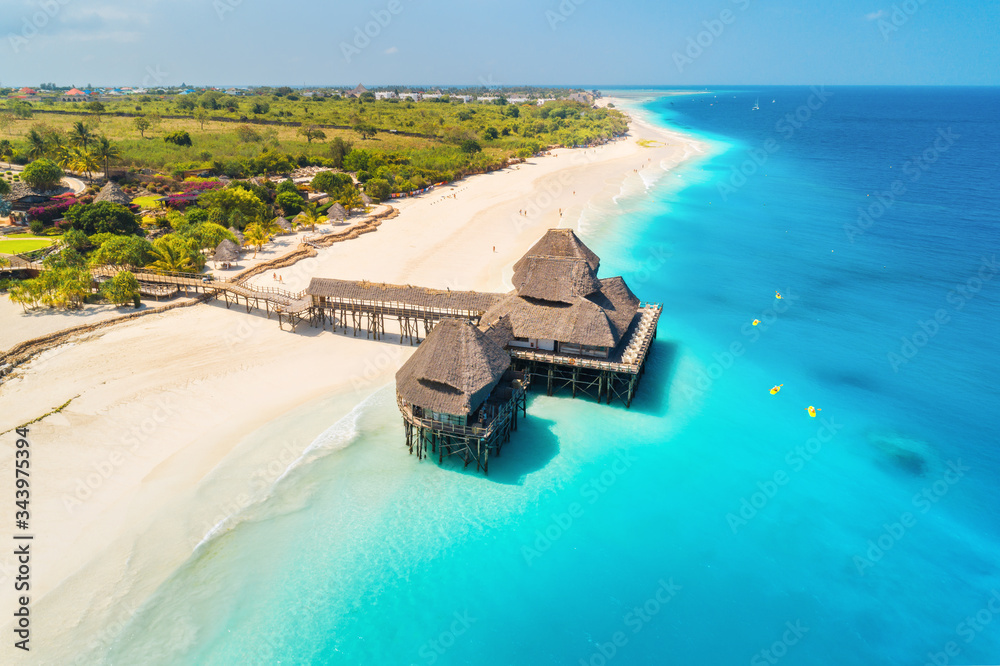 Aerial view of beautiful hotel on the water in ocean at sunny day in summer. Zanzibar, Africa. Top v