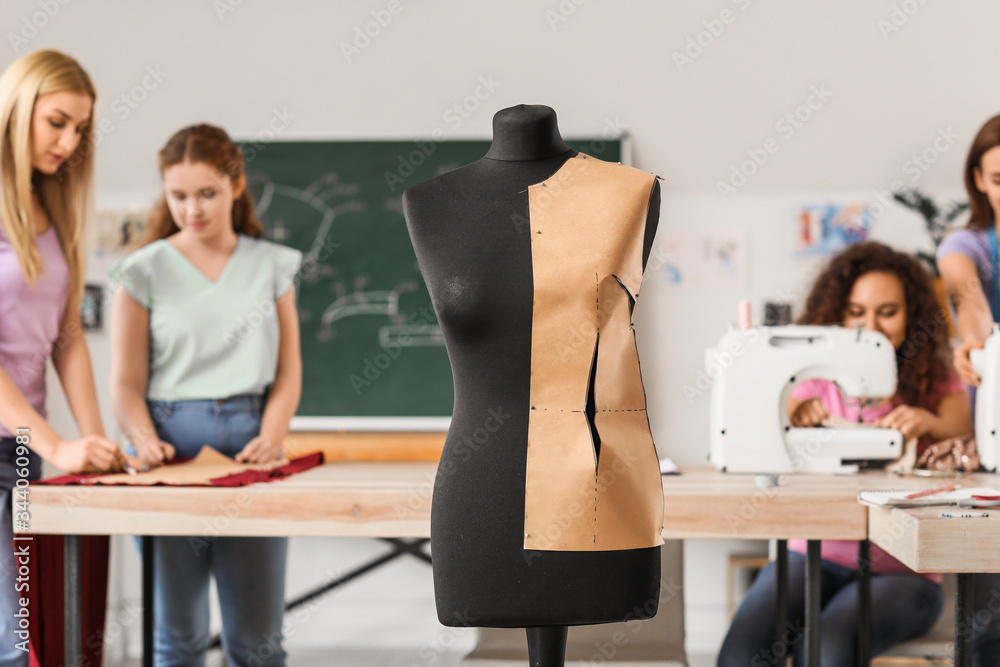 Young women during tailors class in atelier