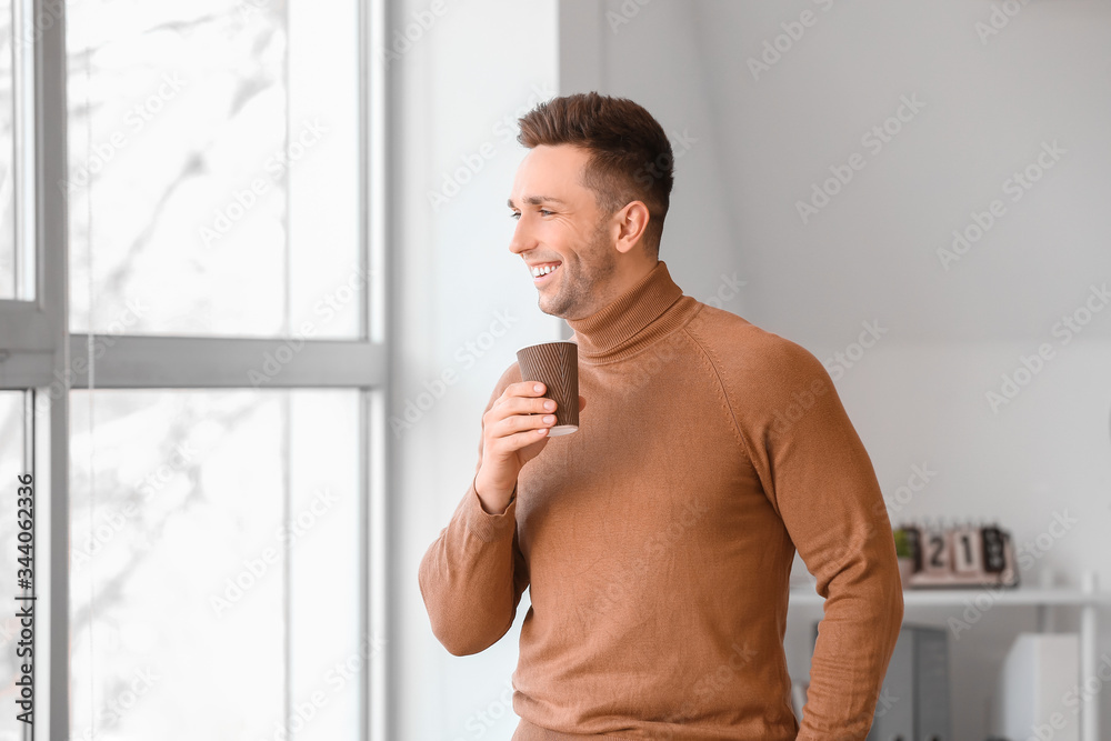 Young man drinking coffee in office