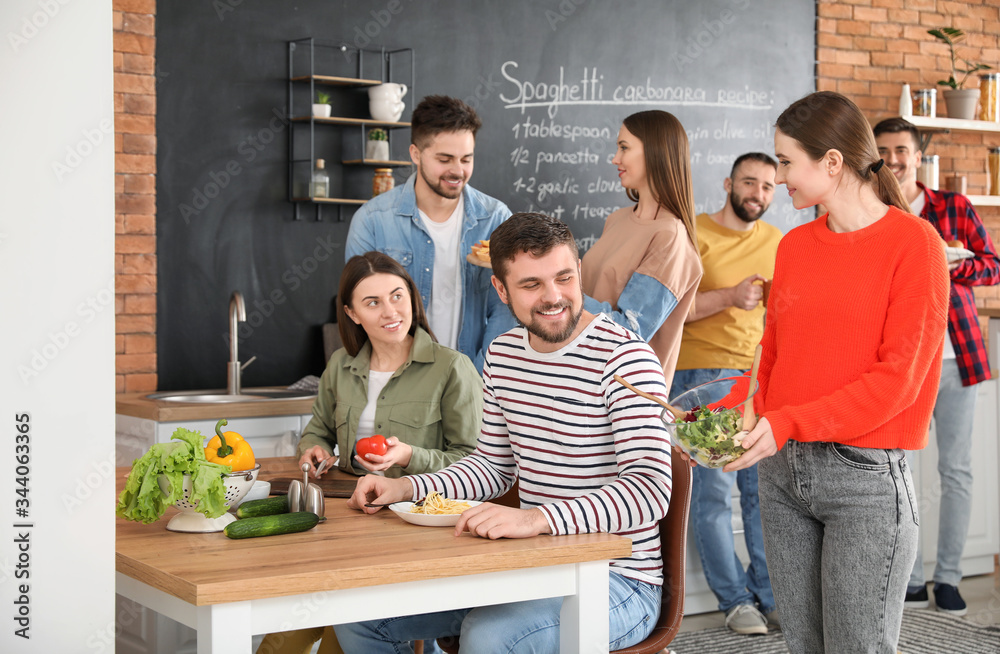 Young friends having dinner together at home