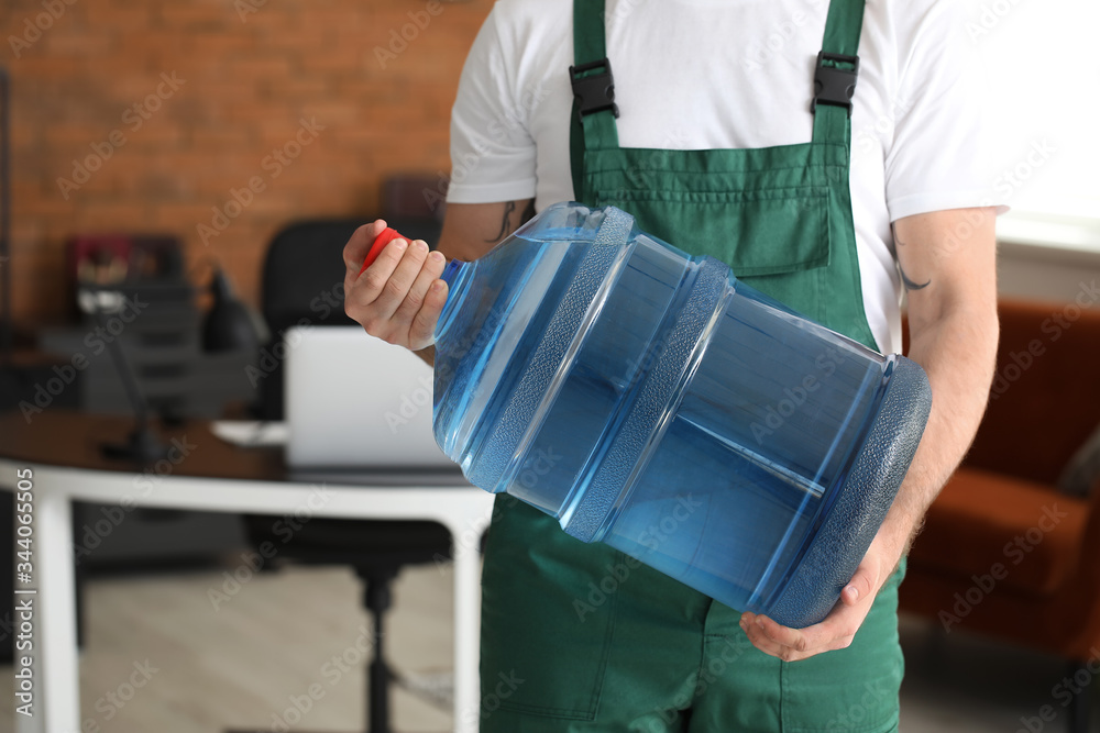 Delivery man with bottle of water in office