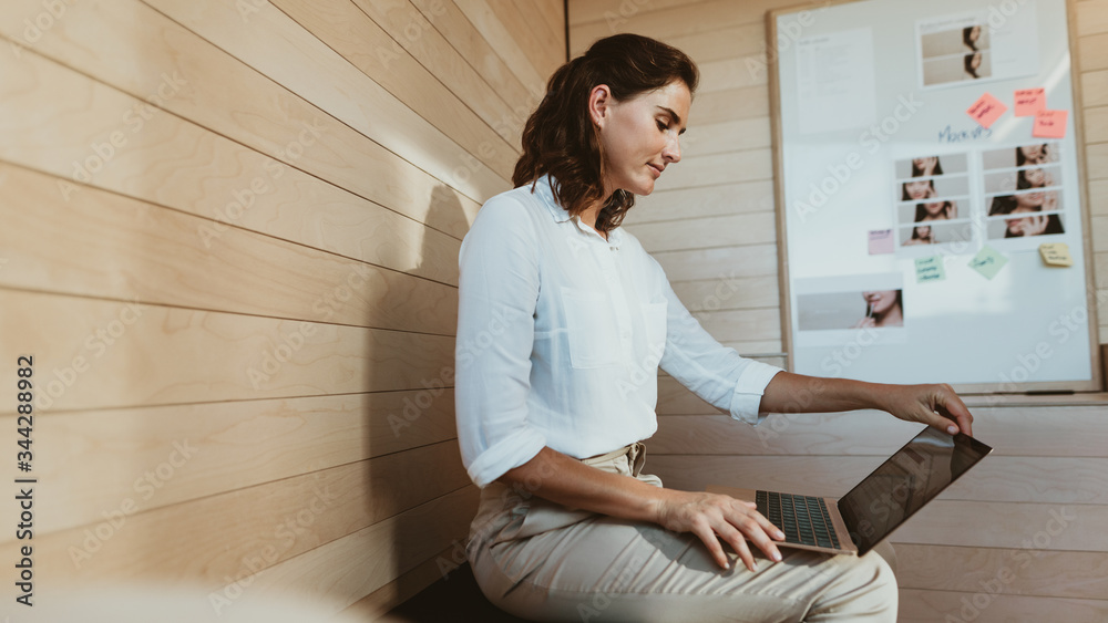 Businesswoman busy working on laptop