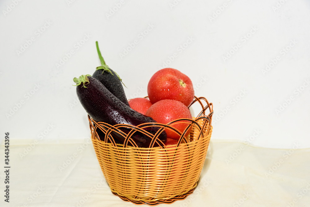 Closeup of fresh ripe vegetables isolated on white background in basket, healthy eating