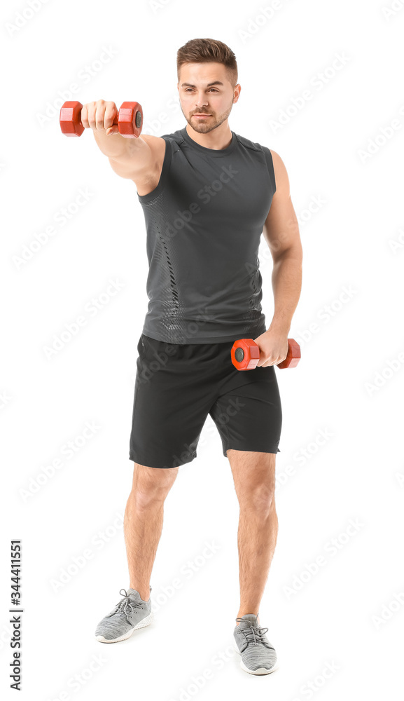 Sporty young man training with dumbbells on white background