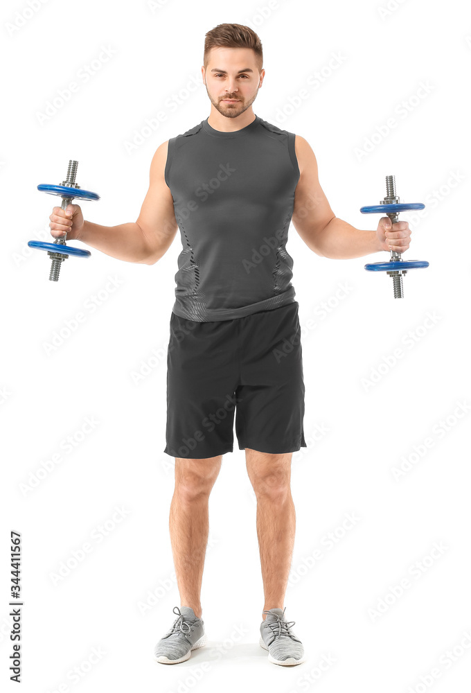 Sporty young man training with dumbbells on white background