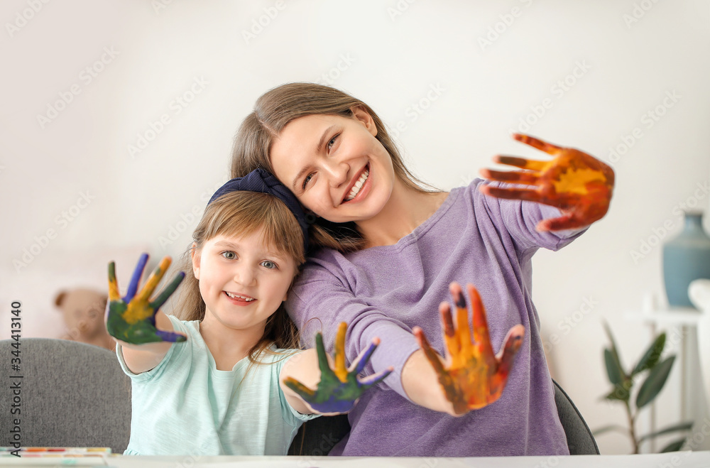 Drawing teacher giving private art lessons to little girl at home