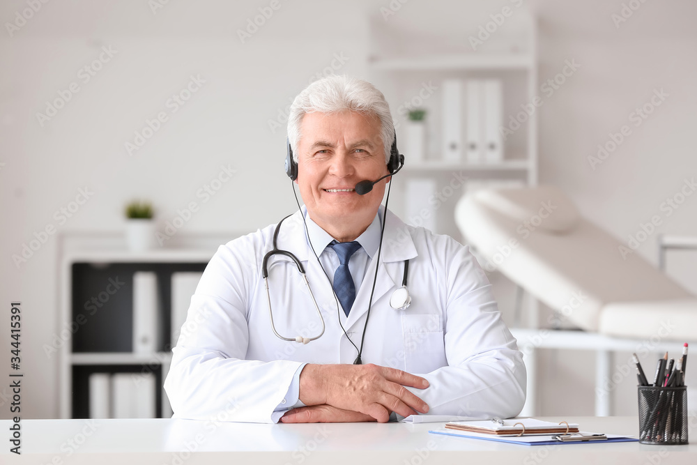 Male doctor giving a consultation online in clinic