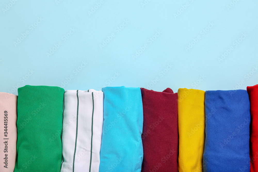 Stylish t-shirts on color background