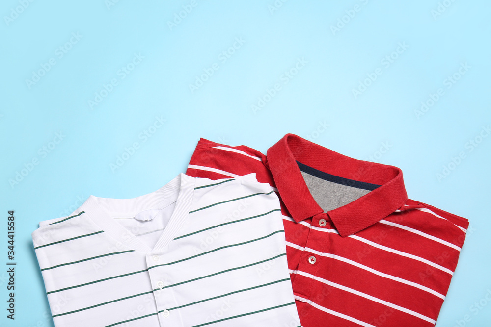 Stylish t-shirts on color background