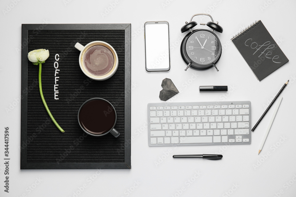 Composition with cups of coffee and different items on white background