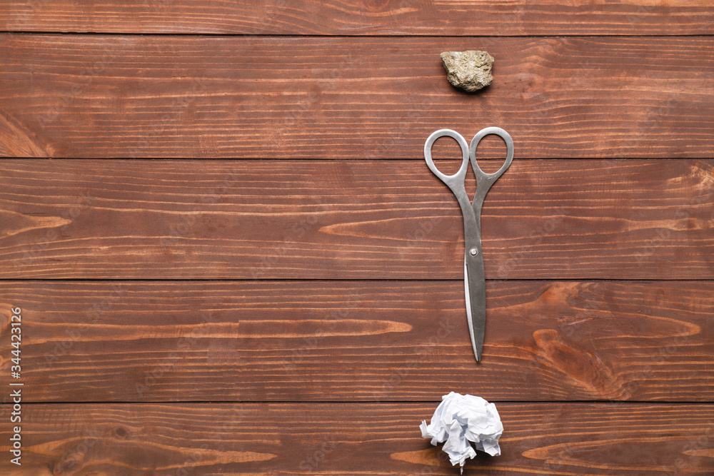 Scissors, rock and paper on wooden background