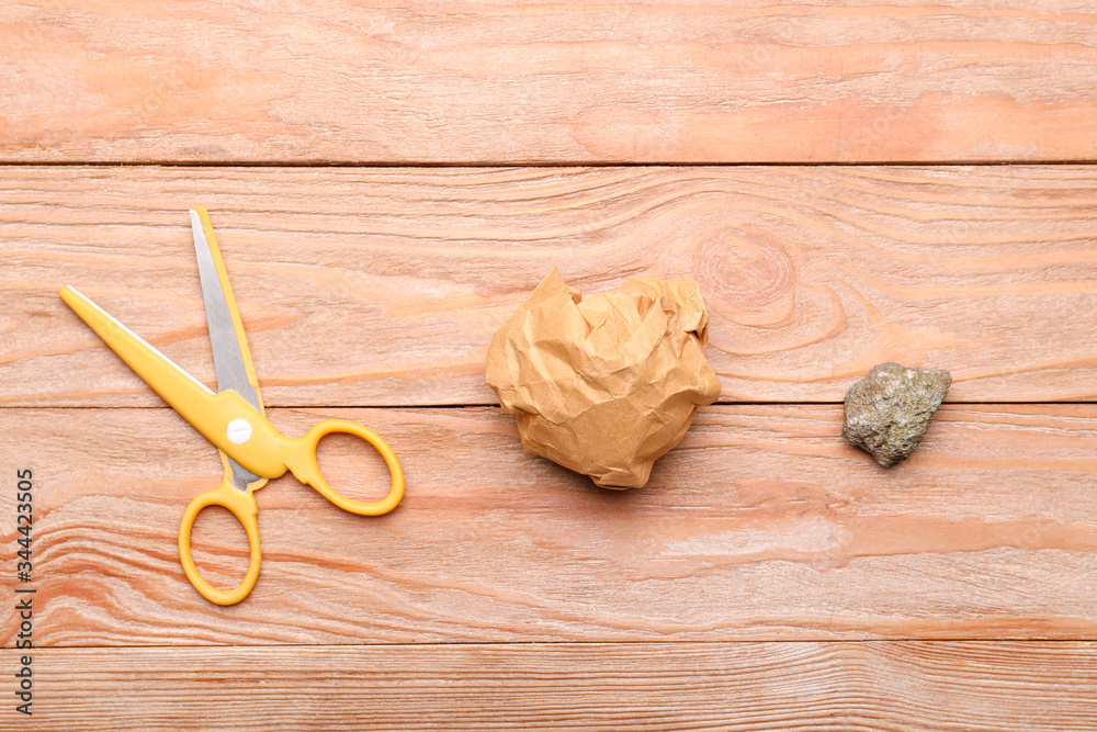 Scissors, rock and paper on wooden background