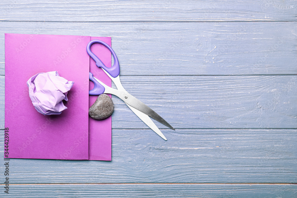 Scissors, rock and paper on wooden background