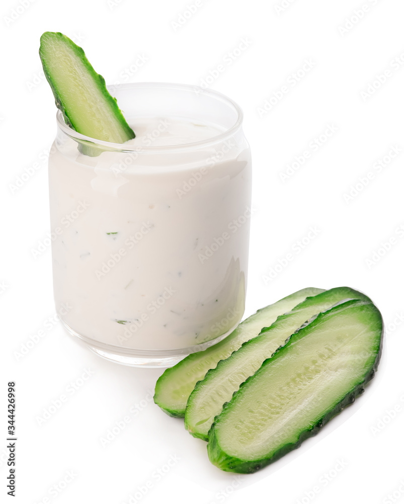 Delicious yogurt sauce with cucumber in jar on white background