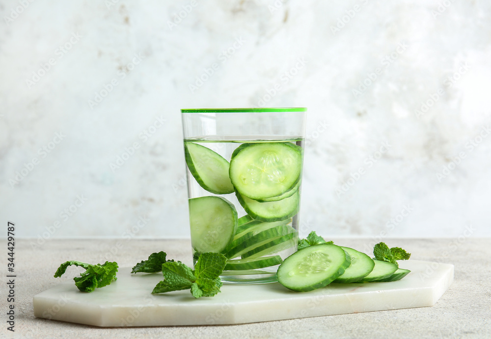 Glass of cucumber infused water on table