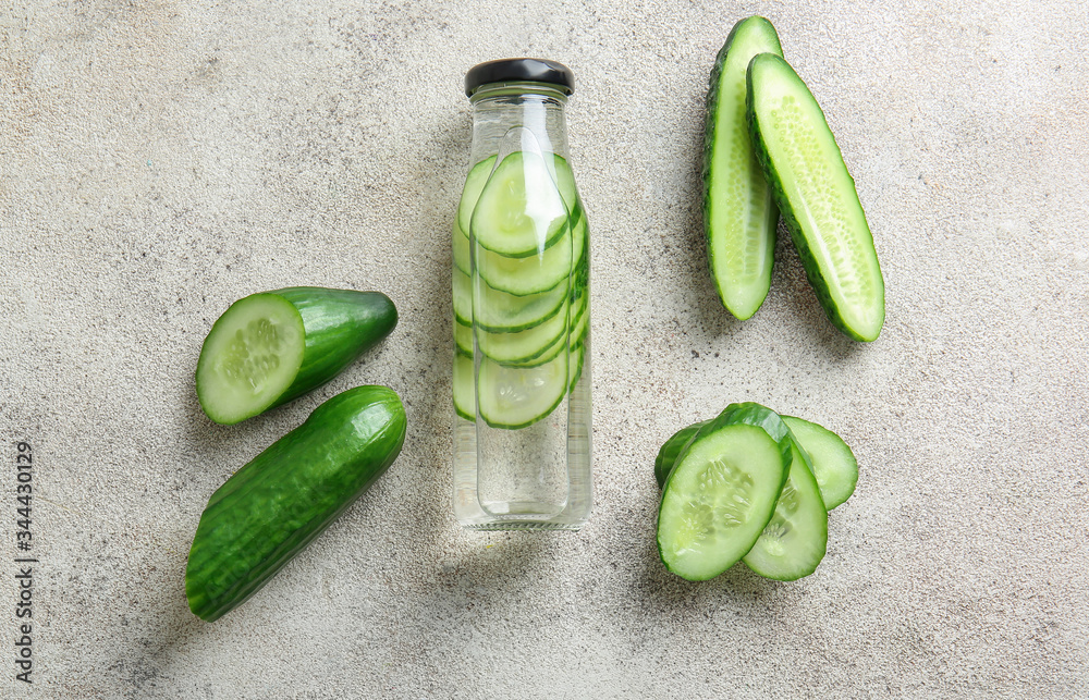 Bottle of cucumber infused water on table