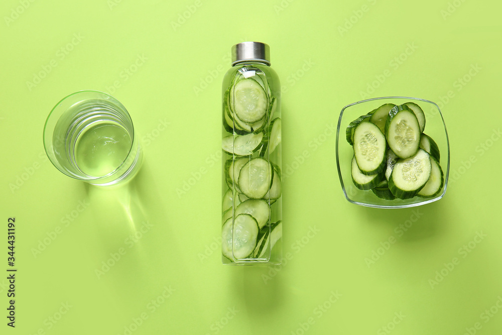 Composition with cucumber infused water on color background