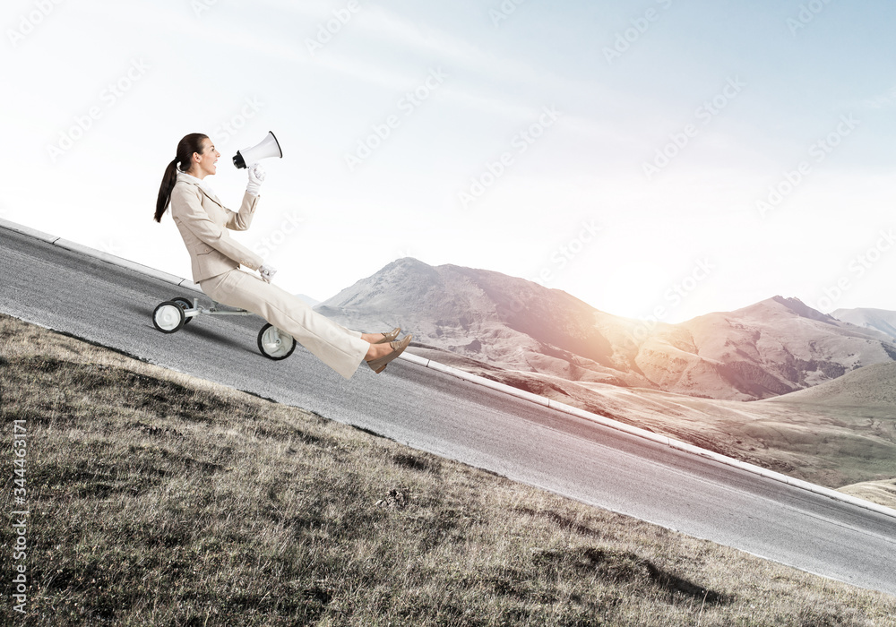 Woman shouting into megaphone and riding