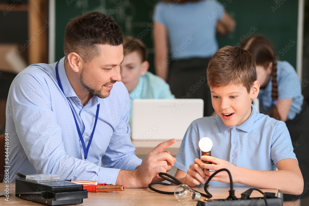 Teacher conducting physics lesson in classroom