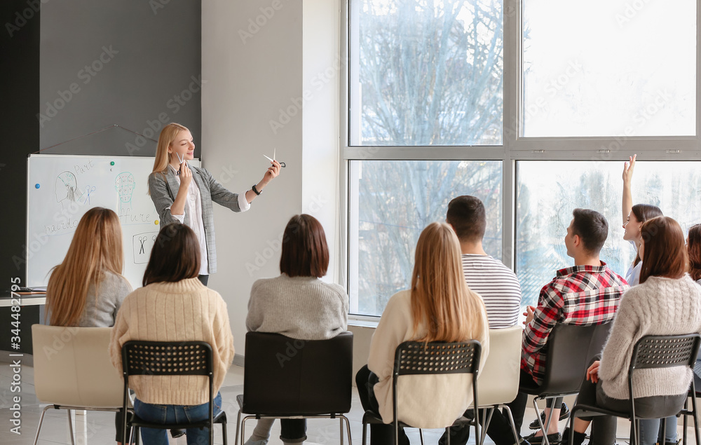 Professional hairdresser teaching young people in office