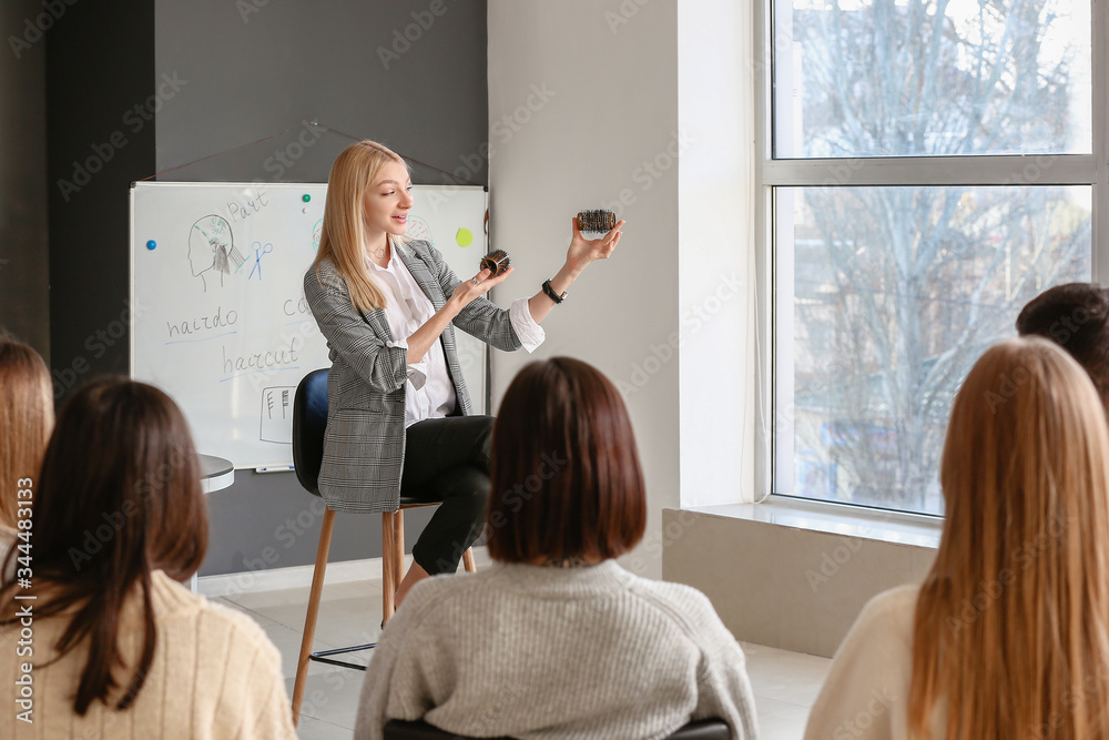 Professional hairdresser teaching young people in office