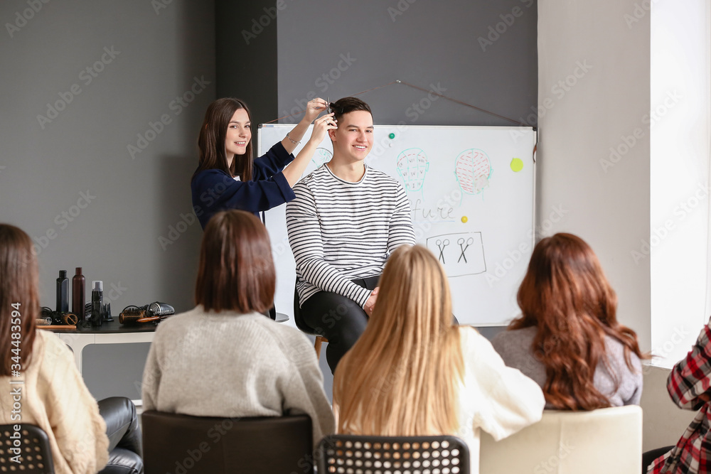 Professional hairdresser teaching young people in office