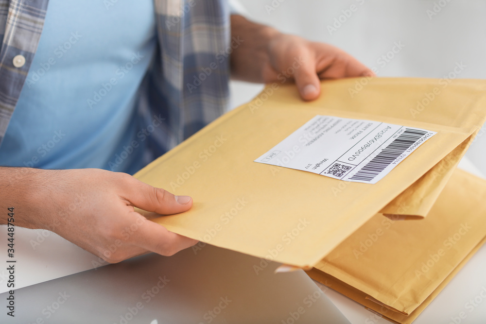 Young man with letters at home, closeup