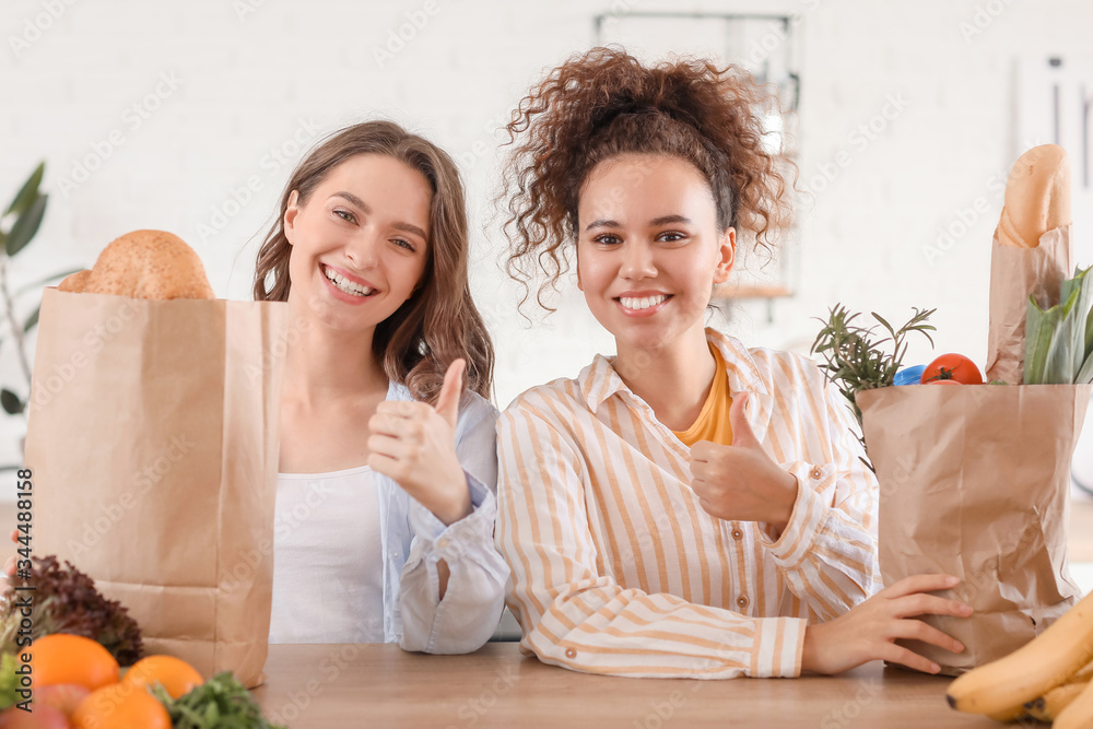 Young women with fresh products from market at home