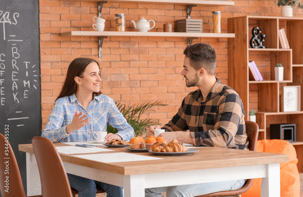 Colleagues drinking coffee in kitchen of office