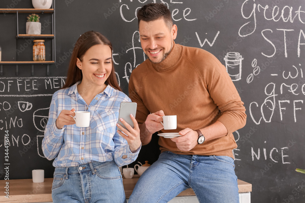 Colleagues drinking coffee in kitchen of office