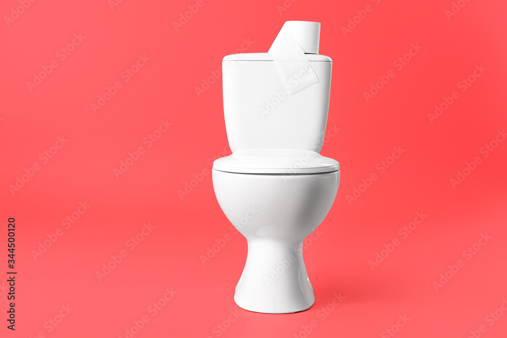 Toilet bowl with roll of paper on color background