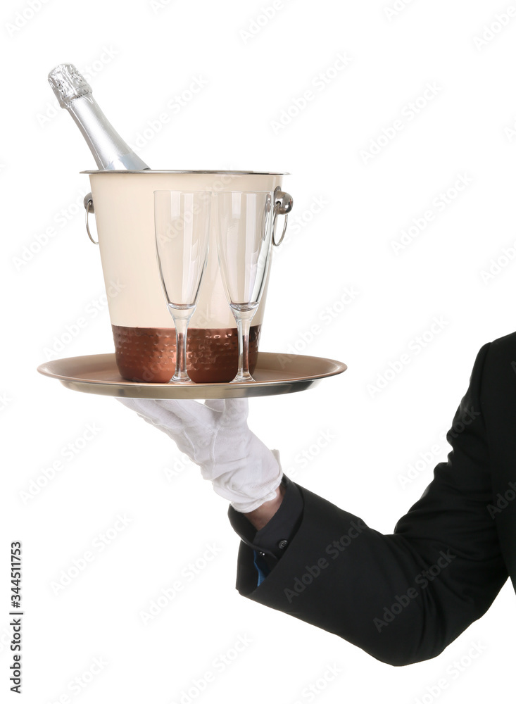 Waiter holding tray with bottle of champagne in bucket and glasses on white background