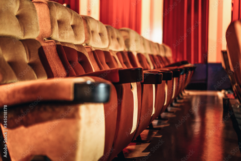 A row of yellow seat with popcorn on chair in the movie theater