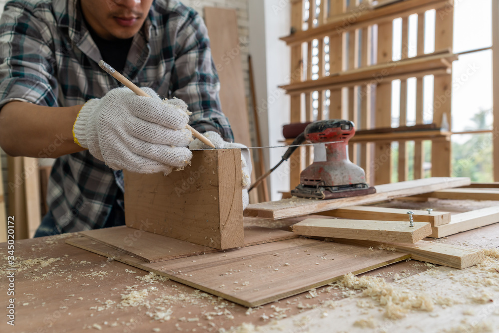 Carpenter working on wood craft at workshop to produce construction material or wooden furniture. Th