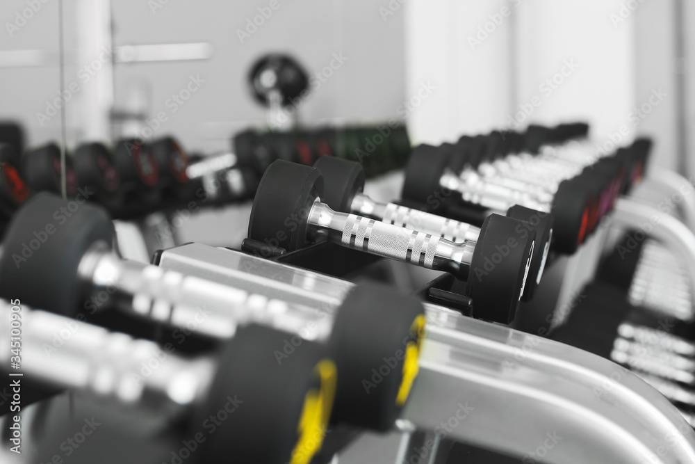 Dumbbells on stand in modern gym