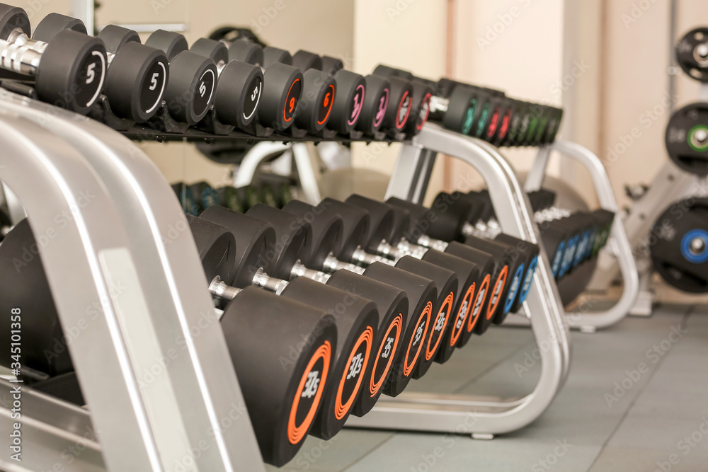 Dumbbells on stand in modern gym