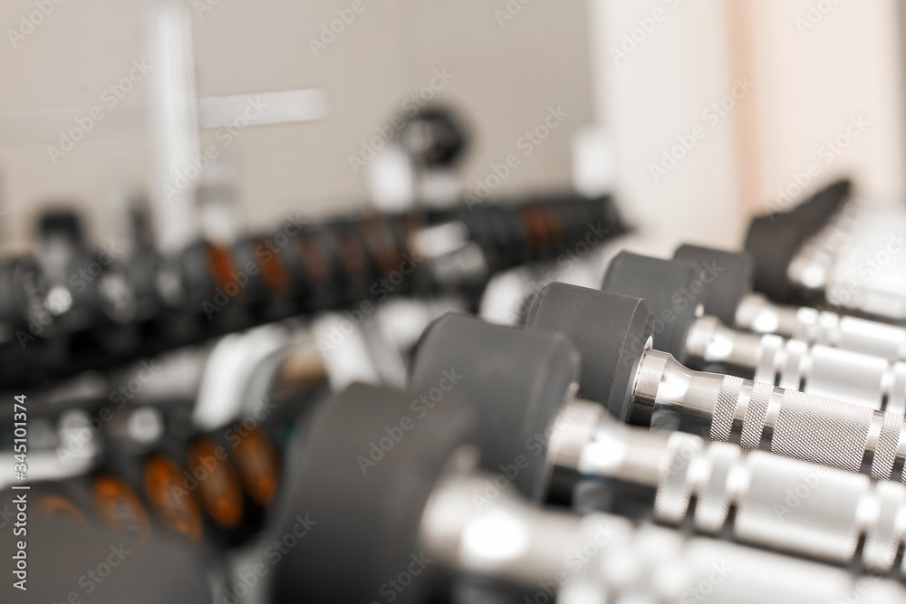 Dumbbells on stand in modern gym