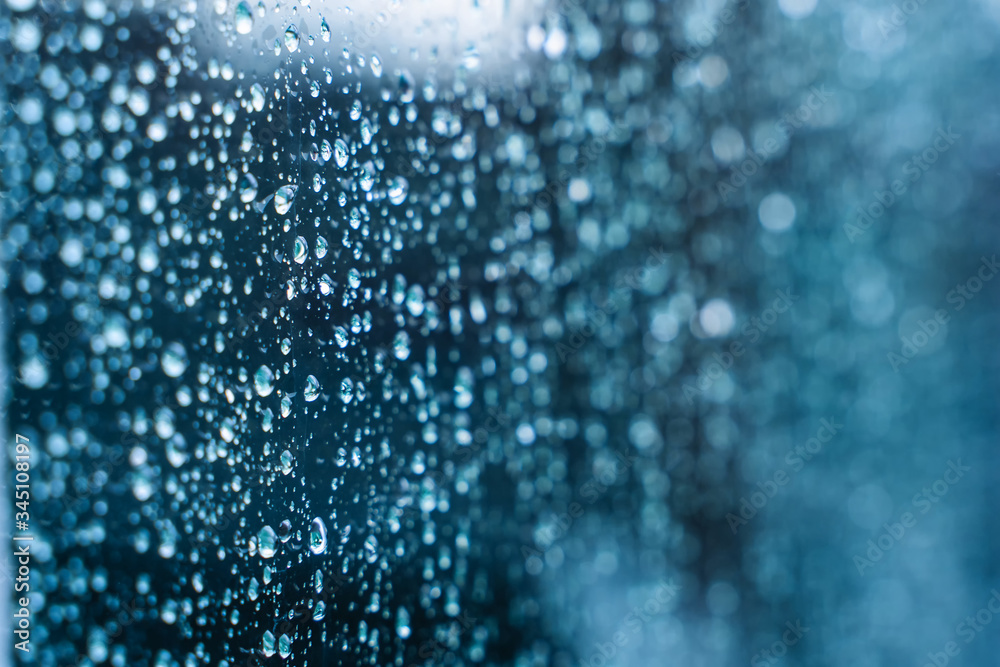 Natural water drop on glass. Selective focus. Rainy city background