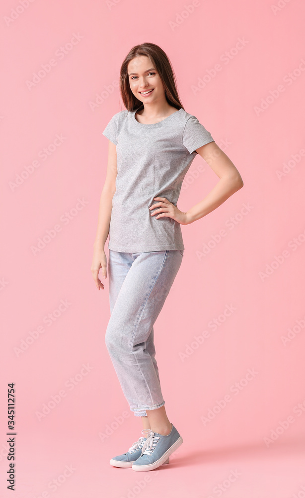 Young woman in stylish t-shirt on color background