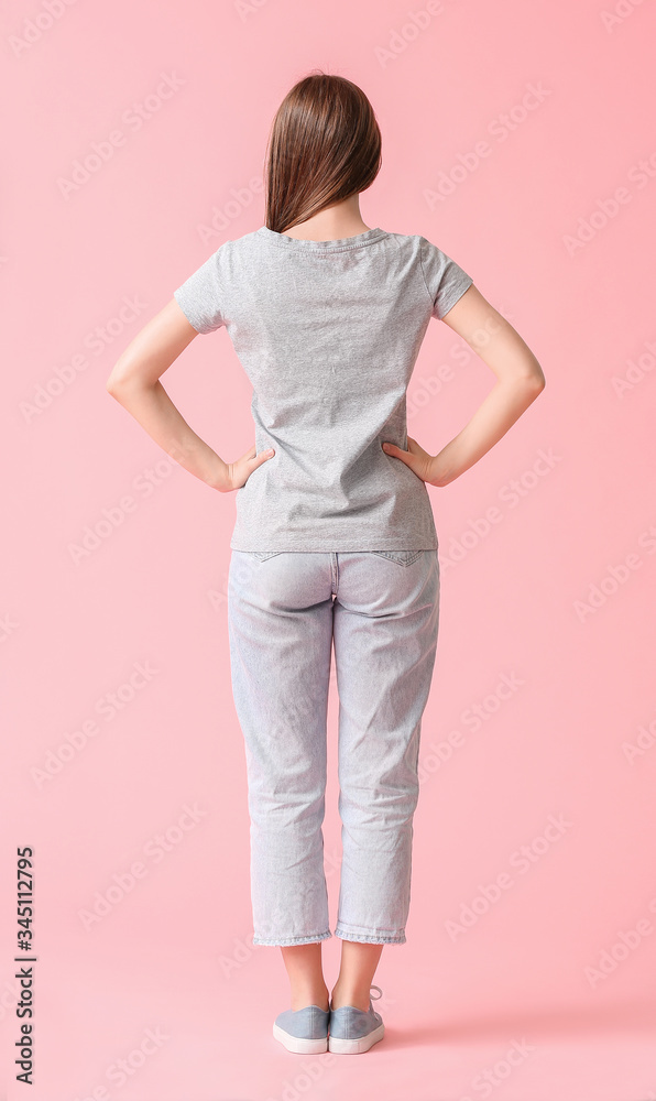 Young woman in stylish t-shirt on color background