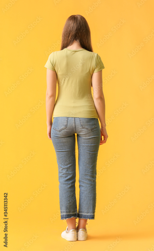 Young woman in stylish t-shirt on color background