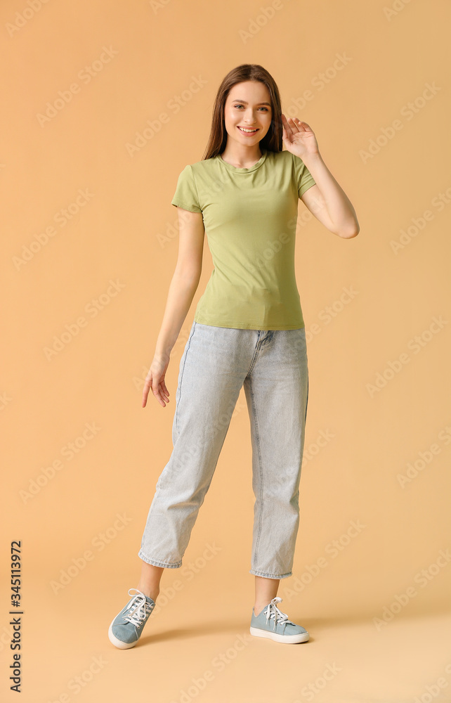 Young woman in stylish t-shirt on color background